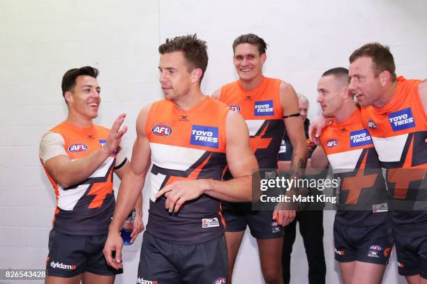 Brett Deledio of the Giants celebrates victory with team mates after the round 20 AFL match between the Greater Western Sydney Giants and the...