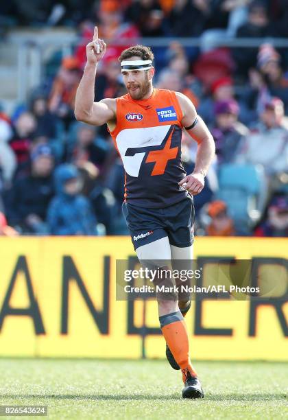 Shane Mumford of the Giants celebrates a goal during the round 20 AFL match between the Greater Western Sydney Giants and the Melbourne Demons at...