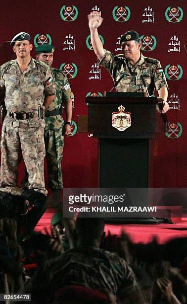 Jordan's King Abdullah II waves to troops next to his brother Prince Faisal at a military base in Zarqa city near Amman late September 3, 2008. The...