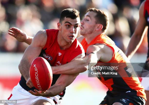 Corey Maynard of the Demons handballs during the round 20 AFL match between the Greater Western Sydney Giants and the Melbourne Demons at UNSW...