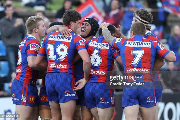 Knights players celebrate a try during the round 22 NRL match between the Newcastle Knights and the New Zealand Warriors at McDonald Jones Stadium on...