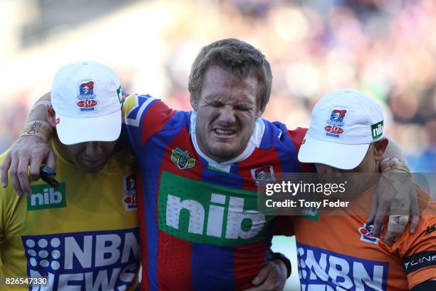 Nathan Ross of the Knights is taken from the ground after getting injured during the round 22 NRL match between the Newcastle Knights and the New...