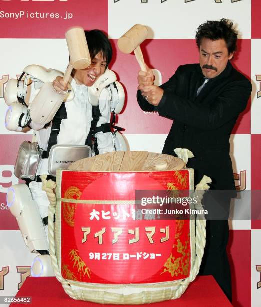 Robert Downey Jr. And a man wearing powered suit, HAL crack a sake barrel to wish for the success of "Iron Man" during the Japan Premiere at Tokyo...