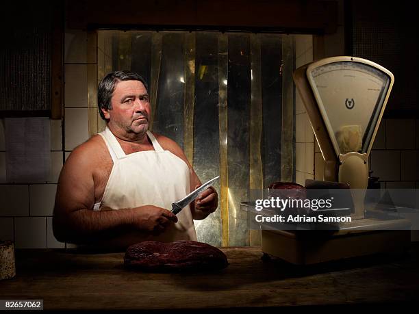 butcher feeling sharpness of knife with thumb - butcher stock pictures, royalty-free photos & images