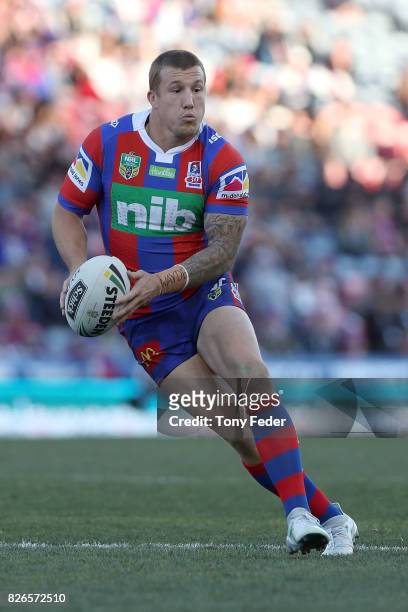 Trent Hodkinson of the Knights looks to pass the ball during the round 22 NRL match between the Newcastle Knights and the New Zealand Warriors at...