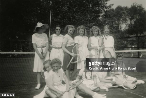 Margot Frank , sister of Anne Frank, on a tennis court in Amsterdam with a group of friends, circa 1941.