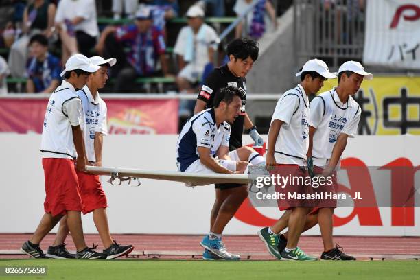 Jungo Fujimoto of Gamba Osaka is taken off by a stretcher during the J.League J1 match between Ventforet Kofu and Gamba Osaka at Yamanashi Chuo Bank...