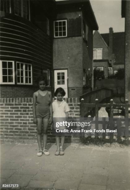 Anne Frank and her older sister Margot at Zandvoort in the Netherlands, circa 1934.