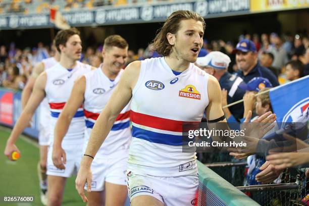 Marcus Bontempelli of the Bulldogs celebrates after winning the round 20 AFL match between the Brisbane Lions and the Western Bulldogs at The Gabba...