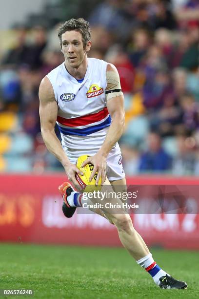 Robert Murphy of the Bulldogs runs the ball during the round 20 AFL match between the Brisbane Lions and the Western Bulldogs at The Gabba on August...