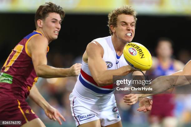 Mitch Wallis of the Bulldogs handballs during the round 20 AFL match between the Brisbane Lions and the Western Bulldogs at The Gabba on August 5,...