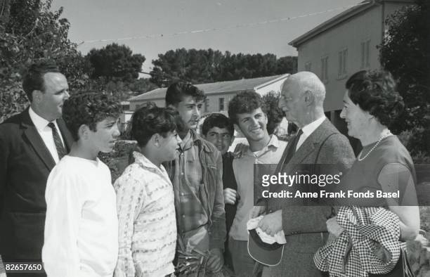 Otto Frank , father of Anne Frank, and his second wife Fritzi with a group of young men at a kibbutz in Israel, circa 1960.