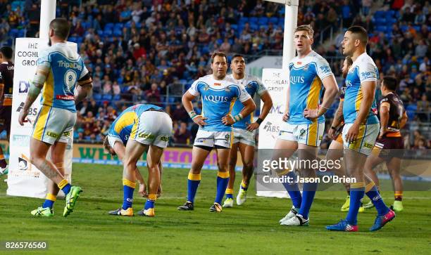 Titans players look dejected during the round 22 NRL match between the Gold Coast Titans and the Brisbane Broncos at Cbus Super Stadium on August 5,...