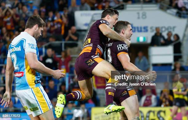 Corey Oates and Ben Hunt of the Broncos celebrate a try during the round 22 NRL match between the Gold Coast Titans and the Brisbane Broncos at Cbus...