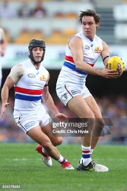 Lukas Webb of the Bulldogs runs the ball during the round 20 AFL match between the Brisbane Lions and the Western Bulldogs at The Gabba on August 5,...