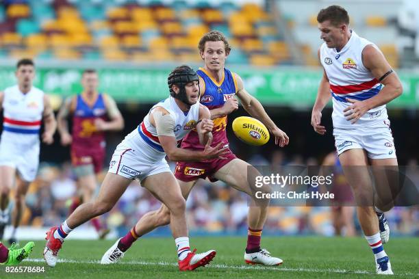 Caleb Daniel of the Bulldogs handballs during the round 20 AFL match between the Brisbane Lions and the Western Bulldogs at The Gabba on August 5,...