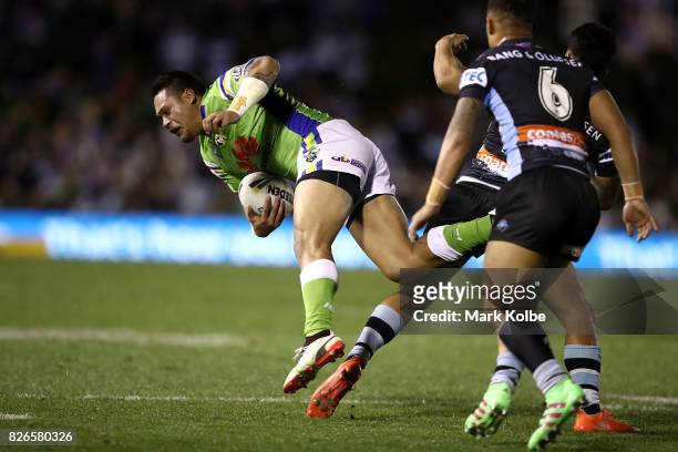 Joseph Leilua of the Raiders is tackled during the round 22 NRL match between the Cronulla Sharks and the Canberra Raiders at Southern Cross Group...