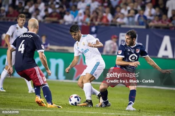 Marco Asensio of Real Madrid tries to work around Michael Bradley of MLS All-Stars and Ignacio Piatti of MLS All-Stars during the MLS All-Star match...