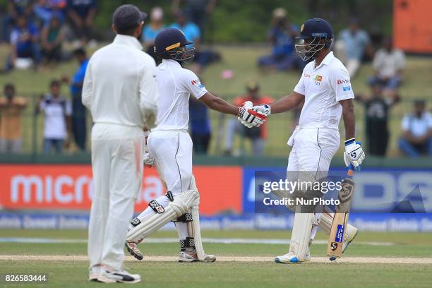 Sri Lankan cricketers Dimuth Karunaratne and Kusal Mendis congratulate each other during the 3rd Day's play in the 2nd Test match between Sri Lanka...