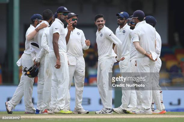 Indian cricketer Ravindra Jadeja is surrounded by his team mates after taking a wicket during the 3rd Day's play in the 2nd Test match between Sri...