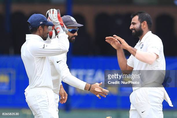 Indian cricketer Mohammed Shami is congratulated by Indian players during the 3rd Day's play in the 2nd Test match between Sri Lanka and India at the...
