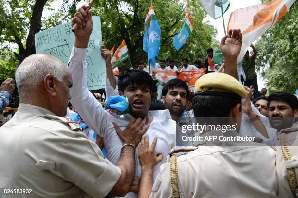 Indian police officers stop activists and supporters of the Indian Youth Congress while shouting slogans against Prime Minister of India Narendra...