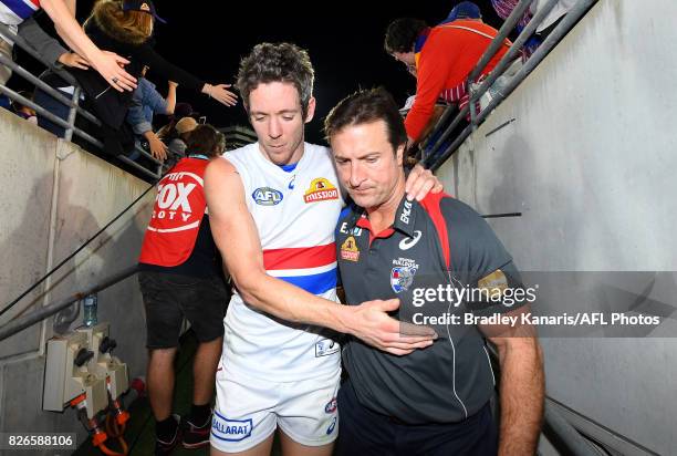 Robert Murphy embraces Coach Luke Beveridge of the Bulldogs after the round 20 AFL match between the Brisbane Lions and the Western Bulldogs at The...