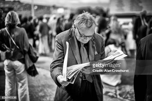 Studying the form on day four of the Qatar Goodwood Festival at Goodwood racecourse on August 4, 2017 in Chichester, England.
