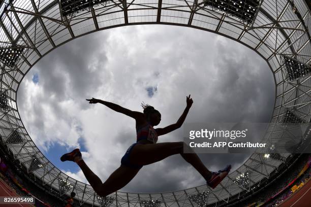 Cuba's Liadagmis Povea competes in the qualifying round of the women's triple jump athletics event at the 2017 IAAF World Championships at the London...