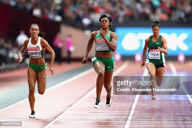 Blessing Okagbare of Nigeria and Ivet Lalova-Collio of Bulgaria competes in the Women's 100 metres heats during day two of the 16th IAAF World...