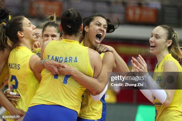 Macris Carneiro, #9 Roberta Silva Ratzke, #11 Tandara Caixeta, #12 Natalia Pereira, #16 Drussyla Costa and team mates of Brazil celebrate winning the...