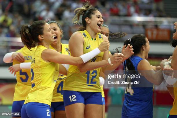 Macris Carneiro, #4 Ana Carolina Silva, #12 Natalia Pereira and team mates of Brazil celebrate winning the semi final match between Brazil and Serbia...
