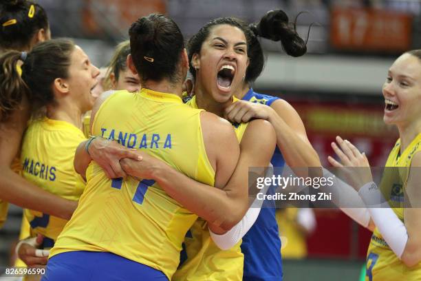 Macris Carneiro, #9 Roberta Silva Ratzke, #11 Tandara Caixeta, #12 Natalia Pereira, #16 Drussyla Costa and team mates of Brazil celebrate winning the...