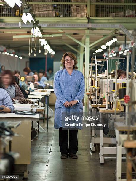 woman and coworkers in factory - textile factory worker stock pictures, royalty-free photos & images