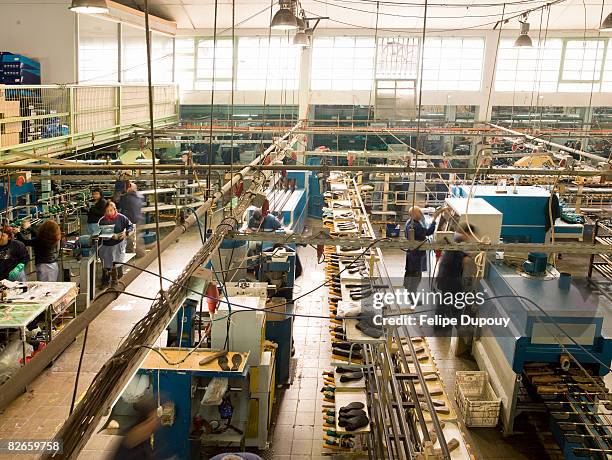 people working in a shoe factory - labor intensive production line stock pictures, royalty-free photos & images