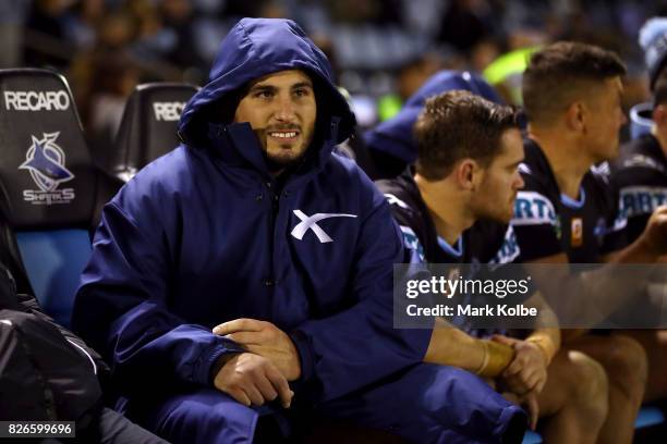 Jack Bird of the Sharks watches on from the bench after leaving the field with an injury during the round 22 NRL match between the Cronulla Sharks...