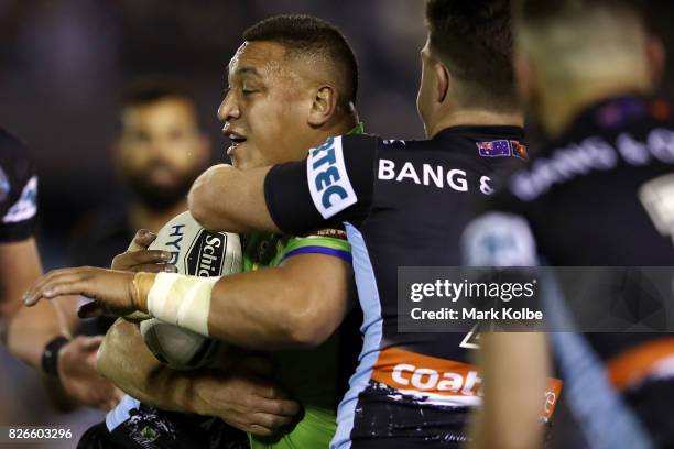 Josh Papalii of the Raiders is tackled during the round 22 NRL match between the Cronulla Sharks and the Canberra Raiders at Southern Cross Group...