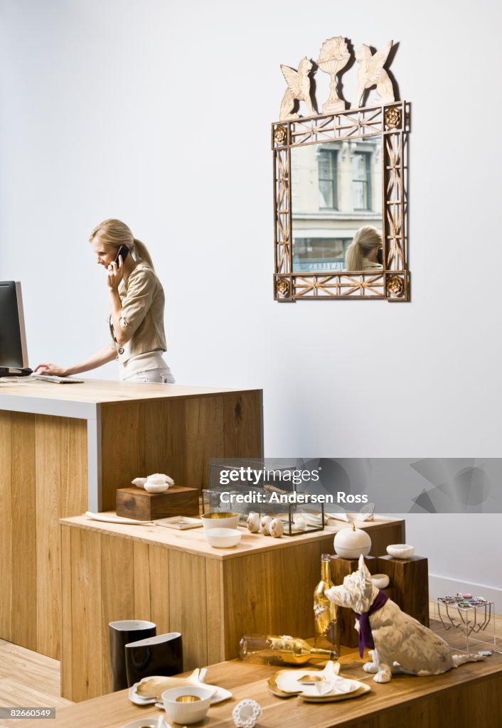 Female shop keeper talking on a tele