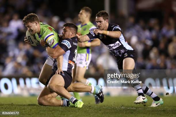 Elliot Whitehead of the Raiders is tackled during the round 22 NRL match between the Cronulla Sharks and the Canberra Raiders at Southern Cross Group...
