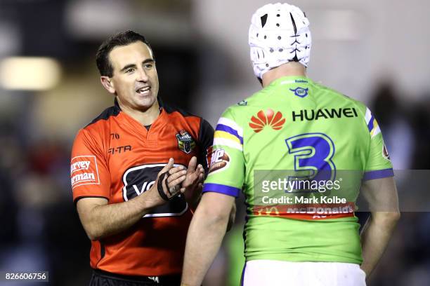 Referee Gerard Sutton speaks to Jarrod Croker of the Raiders during the round 22 NRL match between the Cronulla Sharks and the Canberra Raiders at...