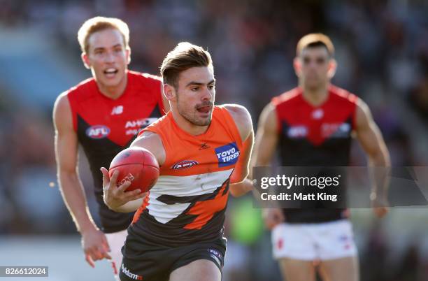 Stephen Coniglio of the Giants carries the ball during the round 20 AFL match between the Greater Western Sydney Giants and the Melbourne Demons at...