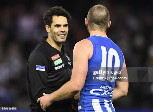 Daniel Wells of the Magpies shakes hands with Ben Cunnington of the Kangaroos during the round 20 AFL match between the North Melbourne Kangaroos and...