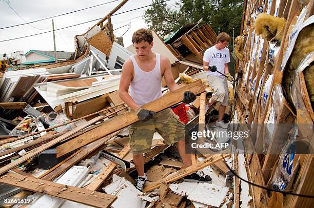 Tate Lefort, Jr., and his school mate Chris Zibilich , work on cleaning up debris on September 4,2008 at The Pickin' Box Crawfish Headquarters in...