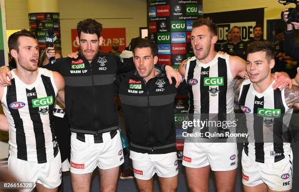 Matthew Scharenberg, Tyson Goldsack, Levi Greenwood, Lynden Dunn and Jamie Elliott of the Magpies sing the song in the rooms after winning the round...