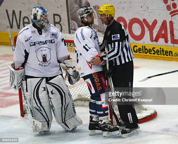 Referee Rick Locker send Sven Felski of the Eisbaeren off the ice after a head-knock during the DEL match between Koelner Haie and Eisbaeren Berlin...