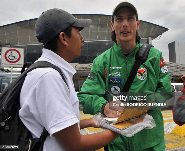 Bolivia's national football player Pablo Escobar signs an autograph to a fan upon arrival at the Mariscal Sucre international airport in Quito on...