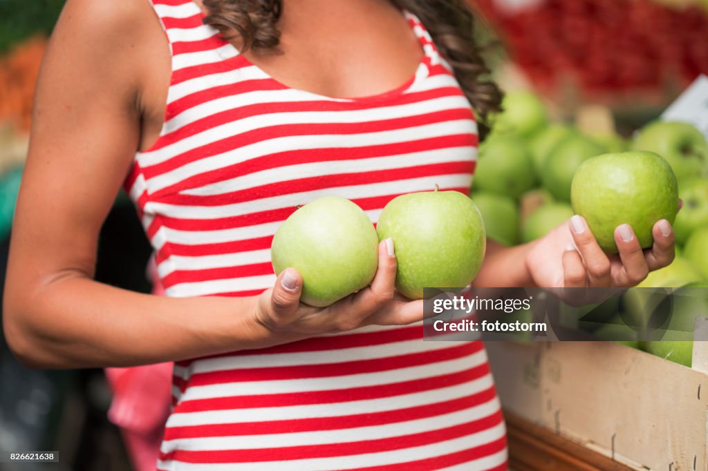 Young woman with apples