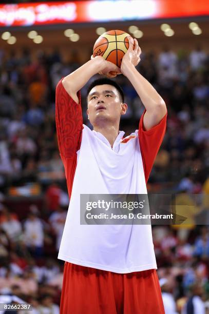 Yao Ming of China warms up before the day 2 preliminary game against the United States at the Beijing 2008 Olympic Games in the Beijing Olympic...