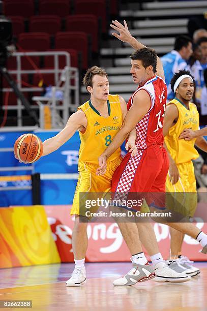 Brad Newley of Australia looks for an open pass around Marko Banic of Croatia during the day 2 preliminary game at the Beijing 2008 Olympic Games in...