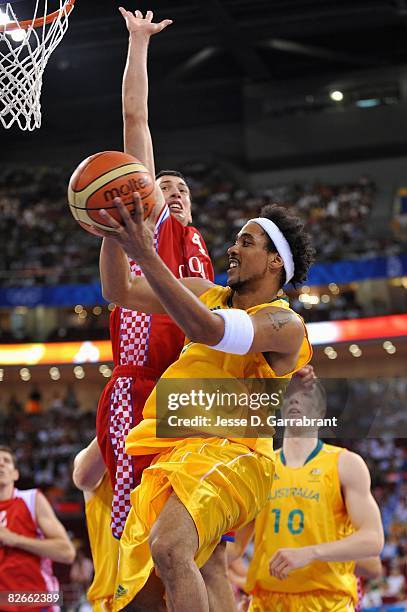 Bruton of Australia lays the ball up past Roko-Leni Ukic of Croatia during the day 2 preliminary game at the Beijing 2008 Olympic Games in the...